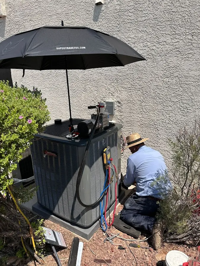 HVAC technician performing outdoor AC maintenance in Port Washington
